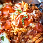 Black spoon scooping up instant pot pizza pasta