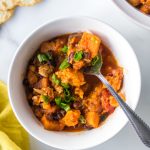 Bowl of Instant Pot turkey black bean sweet potato chili with a spoon in it