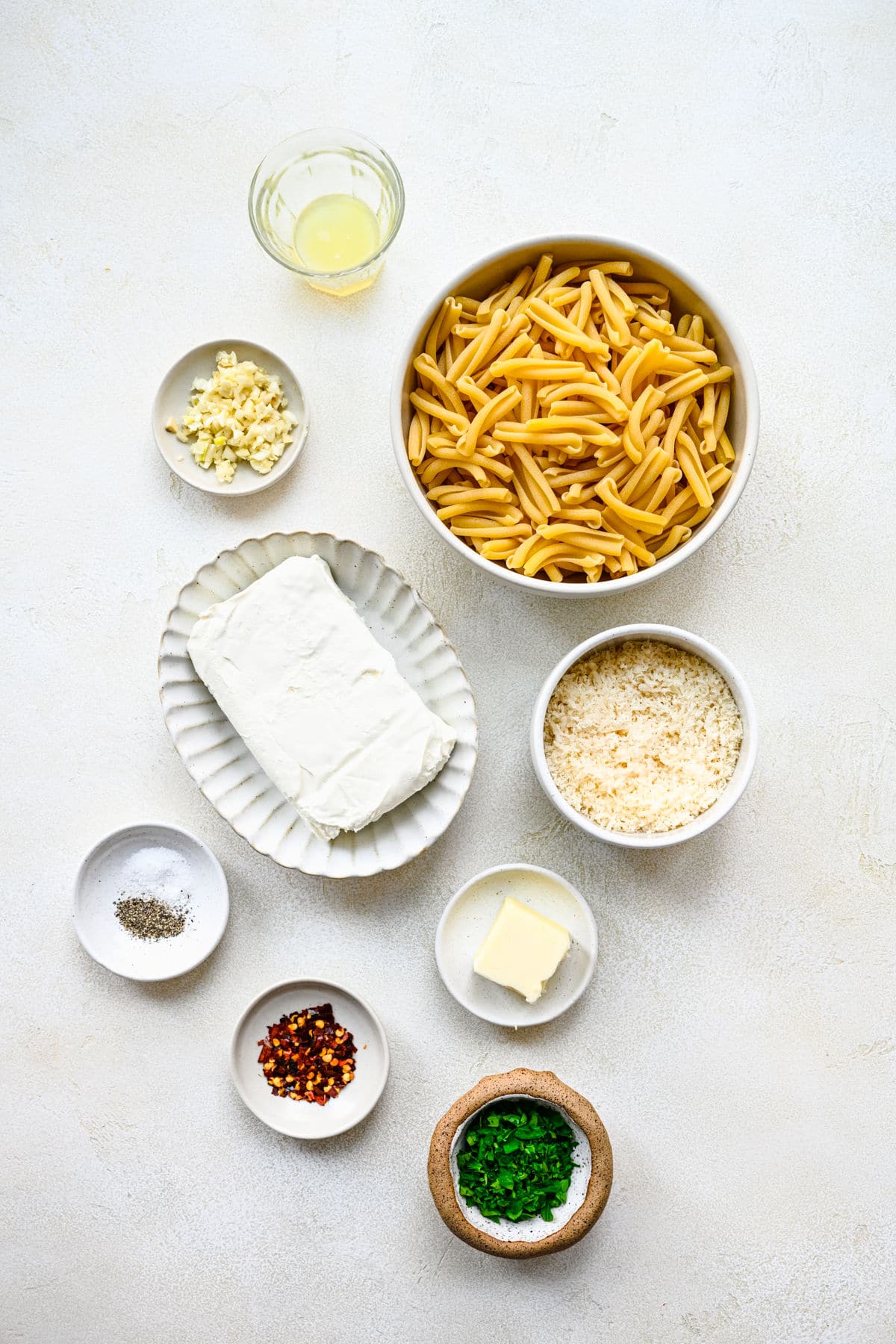 Ingredients for cream cheese pasta in dishes.