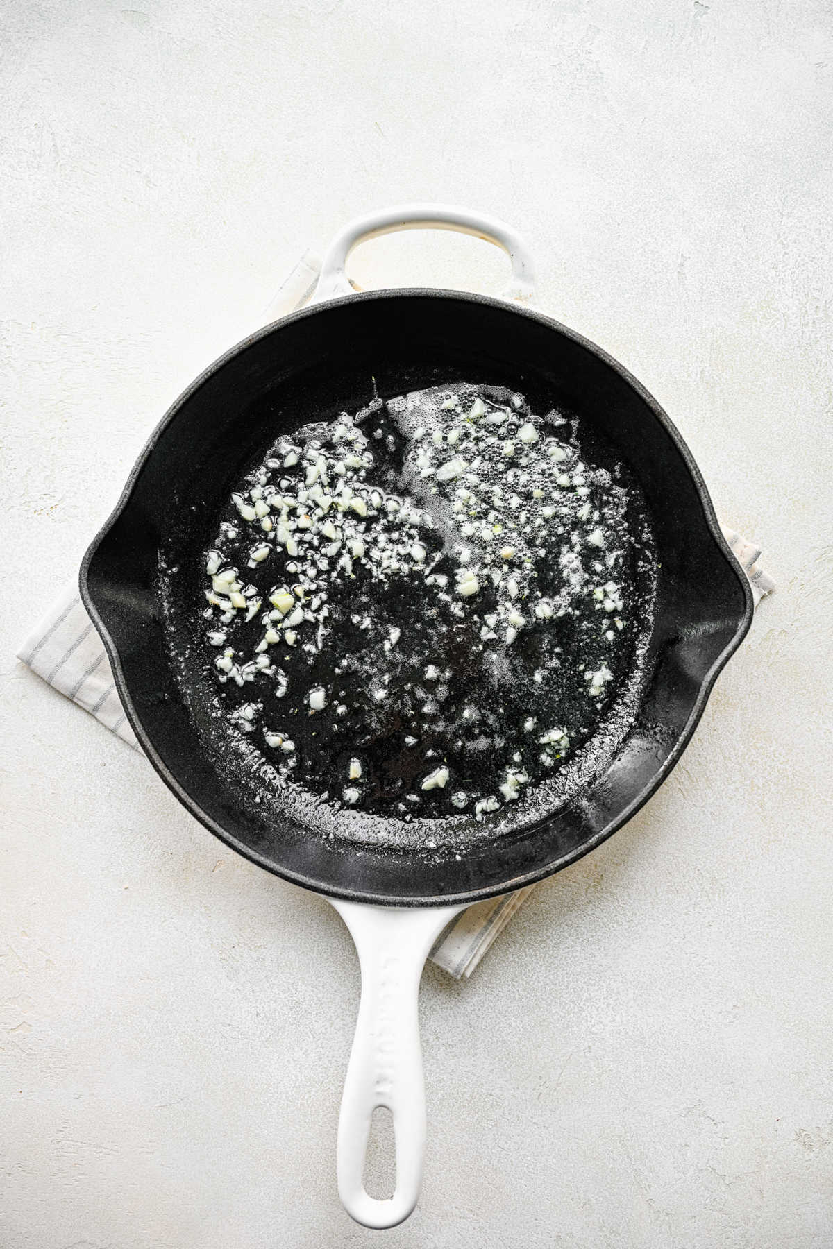 Garlic sauteeing in butter in a skillet. 