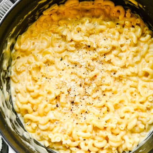 White Dutch oven filled with gouda mac and cheese.