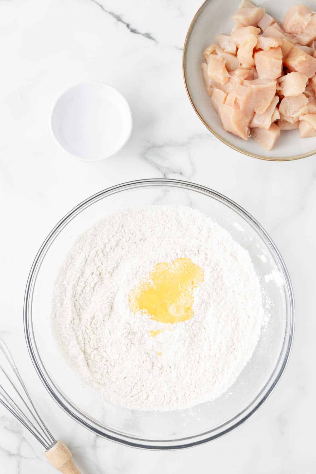 Eggs in dry ingredients in a mixing bowl. 
