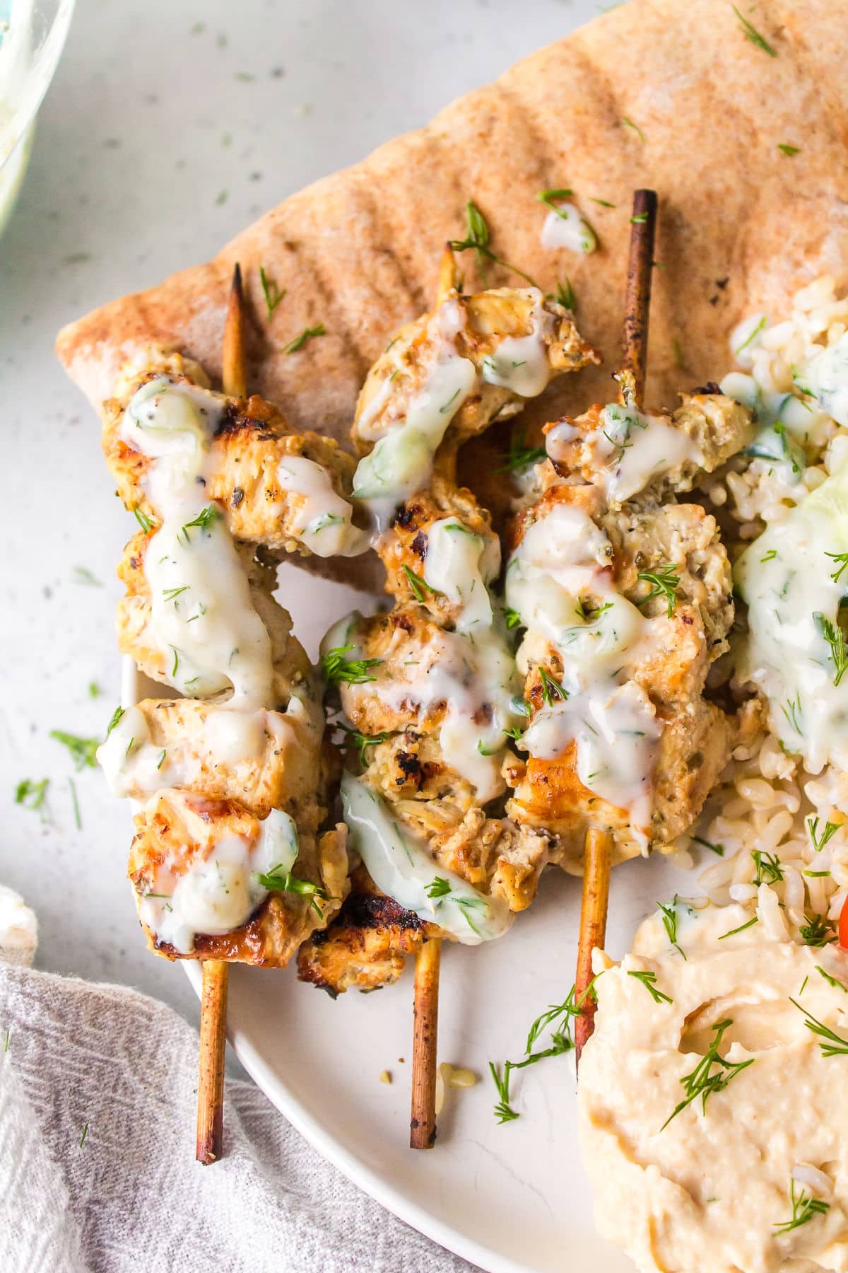 Greek chicken skewers drizzled with homemade tzatziki sauce. 