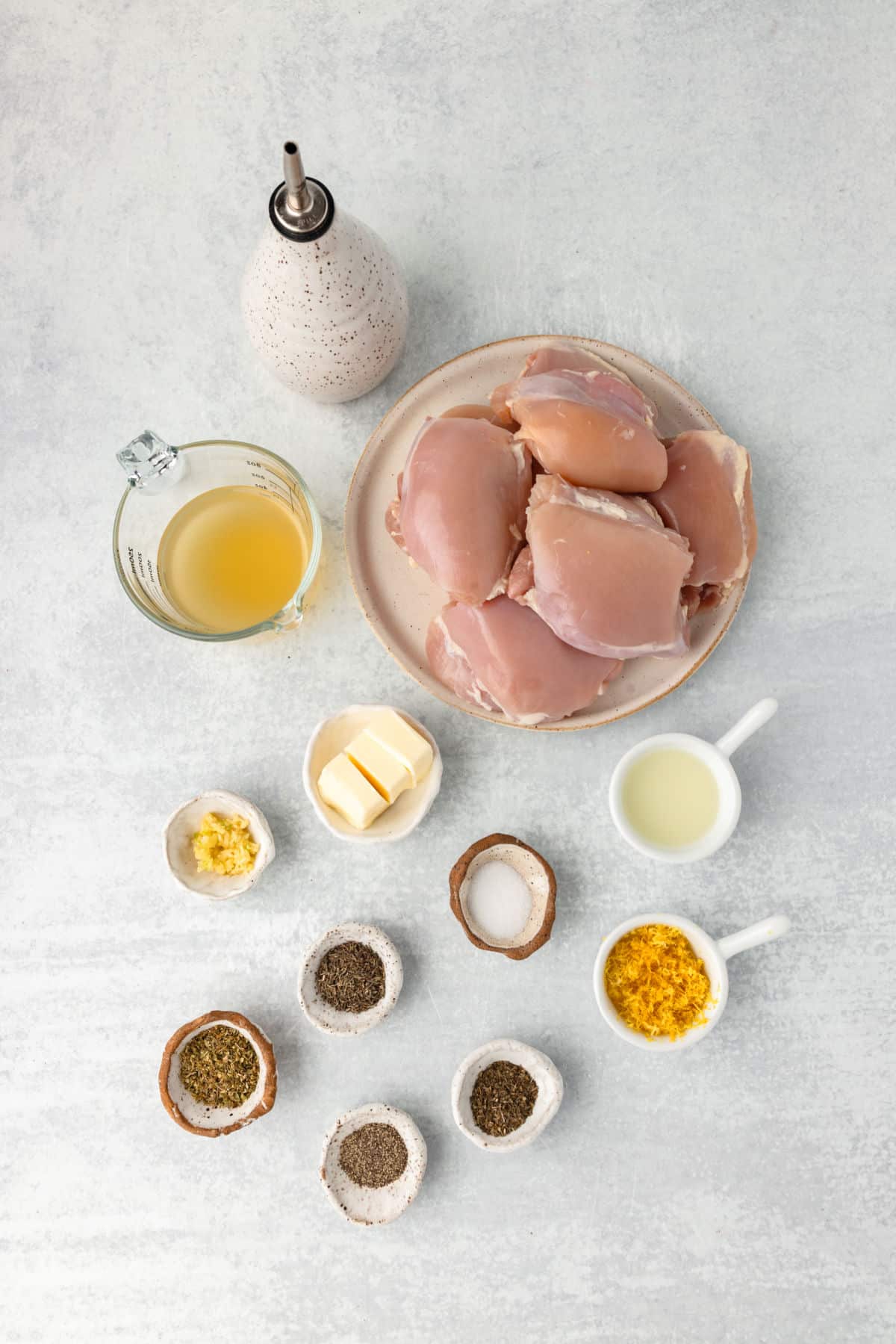 Ingredients for lemon herb chicken thighs in dishes.